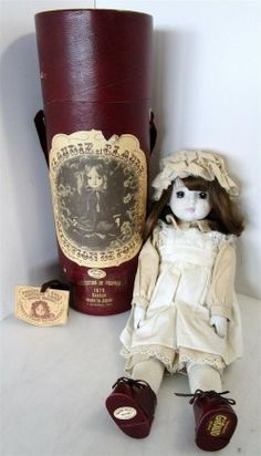 a doll is sitting next to a bottle