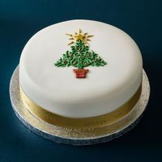 a white cake decorated with a christmas tree