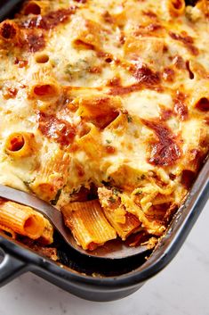 a casserole dish filled with pasta and cheese