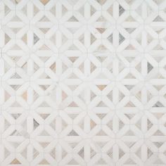 a white tiled wall with geometric designs on it