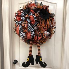 a halloween wreath hanging on the front door