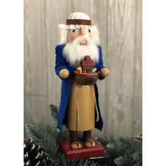 a christmas ornament with a gnome holding a basket