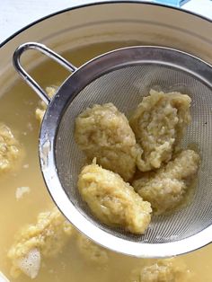 a strainer filled with food sitting on top of a table