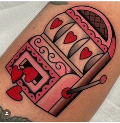 a tattoo with a machine and hearts on it's arm, done by the artist