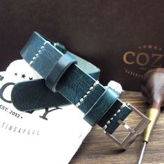 "At Cozy Handmade, we pride ourselves on using the highest quality materials for our products. This watch strap (NAT2) is made of premium full grain Italian veg tanned leather from one of the best tanneries in Italy. The leather features gorgeous texture and natural characteristics which will give your watch an instant rugged and vintage stylish look. Its appearance will get even better with time as it acquires patina, wrinkles and marks. The color of Military 106 is a combination of different s Handmade Blue Watch Bands For Everyday Use, Blue Leather Strap Watch Band For Everyday Use, Handmade Green Watch Bands For Everyday Use, Green Leather Watch Bands For Everyday Use, Nato Strap, Veg Tan Leather, Leather Watch Strap, Leather Conditioner, Brushed Steel