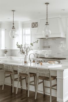 a kitchen with white cabinets and marble counter tops is pictured in this black and white photo