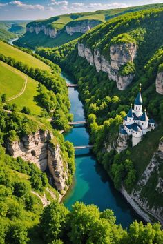 an aerial view of a castle in the middle of a river surrounded by green hills