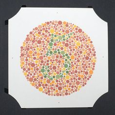 an image of a circle made out of circles on white paper with orange, yellow and green dots