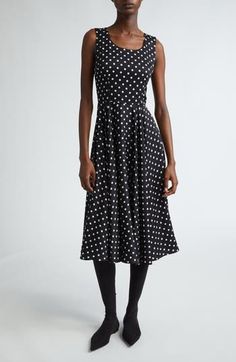 This polka-dot stretch-silk dress is part of D&G's Mambo collection inspired by styles of the '40s and '50s combined with the iconography of American pin-ups. Hidden back-zip closure Jewel neck Sleeveless Stretch-silk lining 91% silk, 9% spandex Dry clean Made in Italy Designer Clothing Black Sleeveless Dress With Fitted Waist, Fitted Polka Dot Midi Dress, Spring Polka Dot Fitted Midi Dress, Polka Dot Midi Length Daywear Dress, Polka Dot Midi Length Dress For Daywear, Fitted Polka Dot Dress For Daywear, Black Fitted Bodice Dress For Daywear, Polka Dot Sleeveless Daywear Dress, Chic Fitted Polka Dot Dress