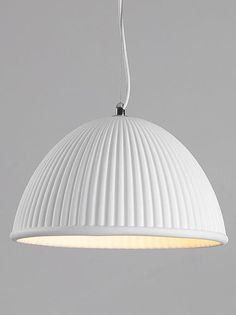 a large white light hanging from a ceiling