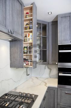 a stove top oven sitting inside of a kitchen next to wooden cabinets and cupboards