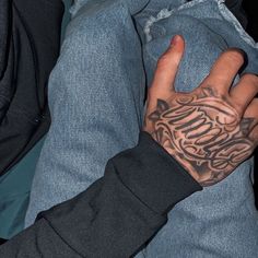 a person with tattoos on their arm and hand