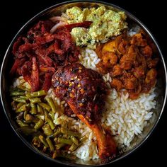 a plate filled with rice, meat and vegetables