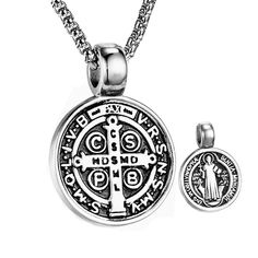 Embrace divine protection with our Serenity Shield Necklace. This powerful pendant features the revered St. Benedict medal, meticulously crafted in sleek stainless steel. The intricate design showcases the saint's figure surrounded by Latin inscriptions, believed to ward off evil and bring blessings. The bold, monochromatic style adds a contemporary edge to this timeless symbol of faith. Whether worn as a personal talisman or gifted to a loved one, this necklace serves as a daily reminder of spiritual strength and guidance. Vintage-inspired design with strong religious symbolism Premium 316L stainless steel - Lightweight, hypoallergenic and tarnish-resistant Retro chain included (24 inches length) Pendant 31mm x 22mm Saint Benedict Pendant - Symbol of Protection and Faith Sao Bento, Catholic Necklace, Anniversary Necklace, St Benedict, Saint Benedict, Style Punk, Festival Wedding, Vintage Inspired Design, Round Pendant