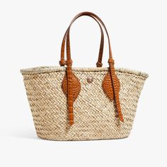 Timeless and posh, Pamela Munson’s straw accessories are beloved by island hoppers and city dwellers alike. Her bags reinterpret straw as a natural, sustainable material that can be worn any season, anywhere. A new take on the classic market tote and seasonal favorite. This traditional Market Tote silhouette has been realized in a lightweight, handwoven seagrass with our signature knot handles in a luxe, crocodile embossed leather. Product Details Handwoven, natural seagrass tote with croc embos Luxury Woven Straw Shopping Bag, Palm Leaf Beach Bag With Braided Handles For Shopping, Natural Straw Bag With Intrecciato Weave, Luxury Straw Bag With Bamboo Handle For Beach, Summer Basket Bag With Intrecciato Weave, Luxury Straw Basket Bag With Braided Handles, Luxury Natural Straw Bag For Shopping, Straw Beach Bag With Leather Handles For Shopping, Natural Straw Bag With Woven Leather And Double Handle