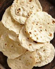 some tortilla chips on a wooden plate