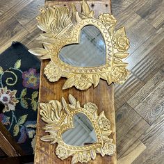 two mirrors sitting on top of a wooden table