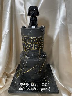 a star wars themed cake with a darth vader helmet on top