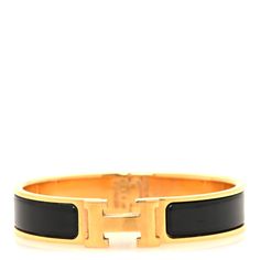 This is an authentic HERMES Enamel Narrow Clic Clac H Bracelet PM in Black. This bracelet is in a gold tone with a hinge on one side and opens with a swivel Hermes "H" on the prominent side. Around the band is a strip of black enamel. Hermes Jewelry Bracelet, H Bracelet, Hermes Bracelet, Hermes Jewelry, Jewelry Bracelet, Black Enamel, Gold Tones, Pouch, Things To Sell