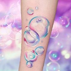 a tattoo with bubbles on the arm