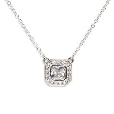 Coveted for its distinctive square shape and brilliant facets, this halo pendant necklace will elevate any look with its statement center stone. The cushion-cut was highly revered in the 19th century and still remains popular today. The chain has been accented with 8 CZ on square bezels. If you are drawn to classy and refined styles, this piece is for you. - Stones Material: Cubic Zirconia. - Stones Shape: Tiny Round and Large Square - Metal: 925 Sterling Silver. - Plating: Rhodium plated. - Cha