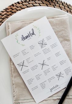 a table setting with place cards and utensils for guests to write their names