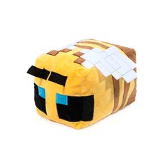 a yellow and brown minecraft pillow sitting on top of a white surface