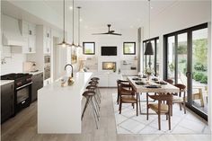 an open kitchen and dining room with sliding glass doors