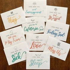 six cards with different phrases on them sitting on top of a wooden table next to each other