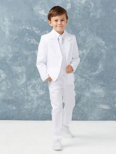 a young boy in a white suit and tie