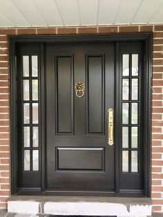 a black front door with two sidelights