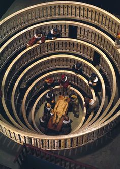 an overhead view of people standing in a spiral staircase