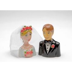 a wedding cake topper with a bride and groom figurine next to each other