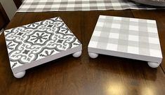 two white and black boxes sitting on top of a wooden table