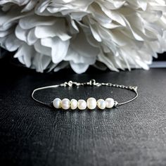 "Lustrous cashmere white Pearls strung on fine sterling silver can be worn as a bracelet or an Anklet. Pearl signifies faith, charity, and innocence. It enhances personal integrity and helps to provide a focus to ones attention. Pearl symbolizes purity and is known as a \"stone of sincerity\". It brings truth to situations and loyalty to a \"cause\". Inhibits boisterous behavior. - 3-5mm Pearls - 3mm Sterling Silver beads - Beads move freely - .5mm Sterling Silver Foxtail Chain - Sterling Silver White Sterling Silver Anklets As Gift, Minimalist Adjustable Pearl Bracelet For Anniversary, Adjustable Sterling Silver Wedding Anklets, Adjustable Sterling Silver Anklets For Wedding, Elegant Adjustable Anklets For Everyday Wear, Dainty Anklet, White Pearl Jewelry, Balance Bracelet, Crystal Properties