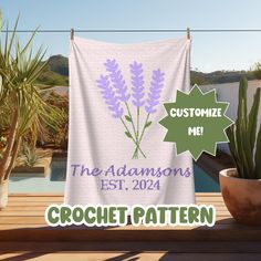 a white towel with purple flowers on it next to a potted plant and the words custom me