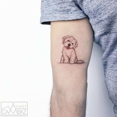 a small dog tattoo on the left inner arm and leg, with a red heart in it's mouth