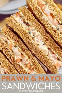 two sandwiches stacked on top of each other with the words prawn and mayo sandwiches