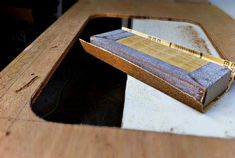 a wooden table with a ruler sticking out of it