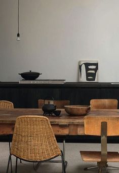 a table with chairs and bowls on it next to a wall that has writing on it