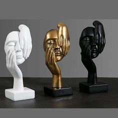 three different types of sculptures sitting on top of a black table next to each other