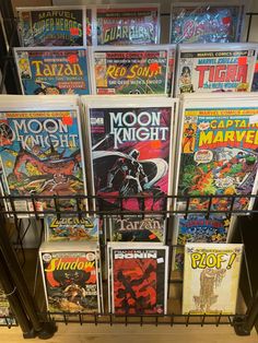 a bunch of comic books are on display