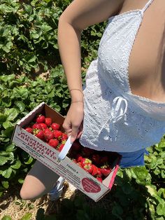 A girl wearing a white tank top and denim shorts is strawberry picking in a field Strawberry Picking Outfit, Siren Core, Oki Doki, Strawberry Picking, 사진 촬영 포즈, Summer Plans, Summer Goals, Spring Aesthetic, Spring Vibes