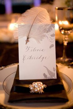 a table setting with place cards and candles