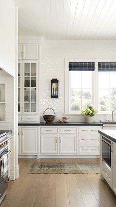 a kitchen with white cabinets and black counter tops is featured on the app store's website