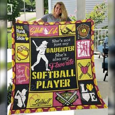 a woman is holding up a softball quilt that says she's not just my daughter, she's also my favorite softball player