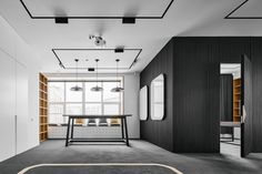 an empty room with black and white decor on the walls, carpeted flooring and open shelving