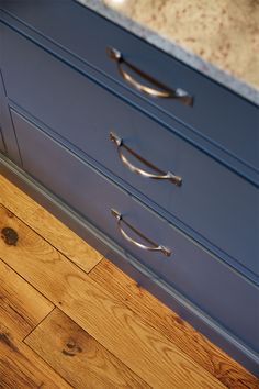 an image of a kitchen counter top with drawers and pulls on the bottom drawer area