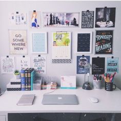 a white desk topped with lots of pictures and papers