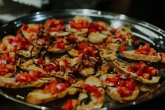 a metal pan filled with lots of food on top of a table